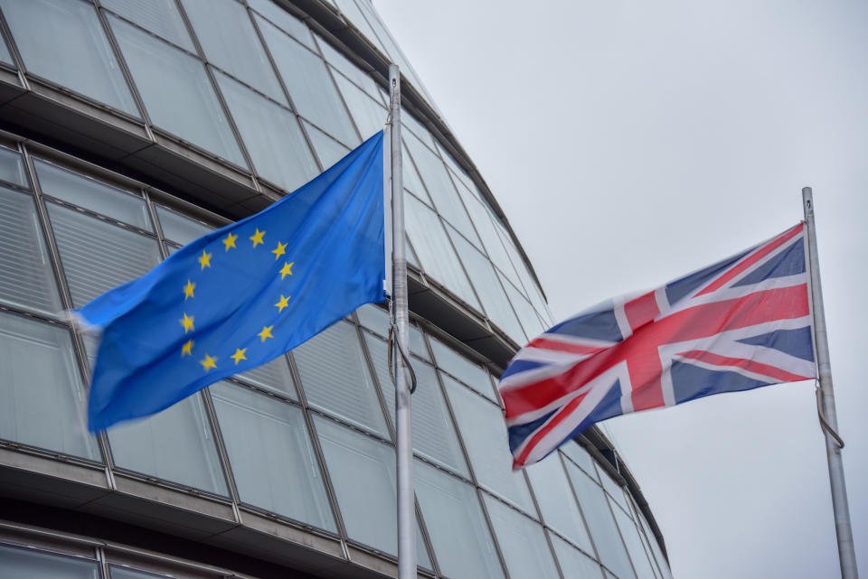 The European Union and the British flags flying on poles outside London City Hall