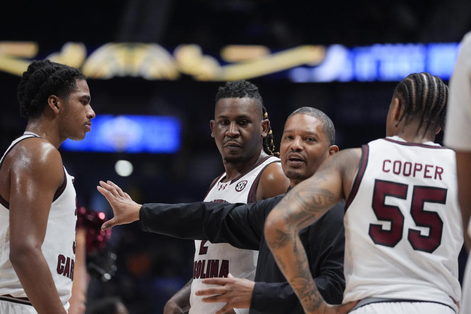 South Carolina head coach Lamont Paris huddles his players during a timeout in the frist half of an NCAA college basketball game against Arkansas at the Southeastern Conference tournament Thursday, March 14, 2024, in Nashville, Tenn. (AP Photo/John Bazemore)