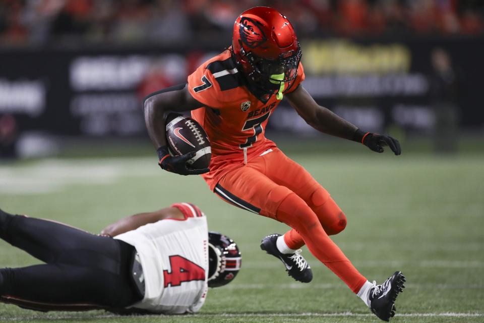 Oregon State wide receiver Silas Bolden (7) slips a tackle by Utah cornerback JaTravis Broughton (4) during the second half of an NCAA college football game Friday, Sept. 29, 2023, in Corvallis, Ore. | Amanda Loman, Associated Press