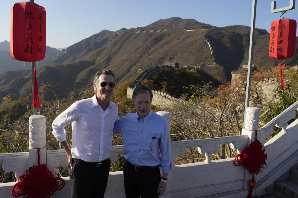 U.S. ambassador to China Nicholas Burns, right and California Gov. Gavin Newsom pose for photos as they visit the Mutianyu Great Wall on the outskirts of Beijing, Thursday, Oct. 26, 2023. Newsom is on a weeklong tour of China where he is pushing for climate cooperation. His trip as governor, once considered routine, is drawing attention as it comes after years of heightening tensions between the U.S. and China. (AP Photo/Ng Han Guan)