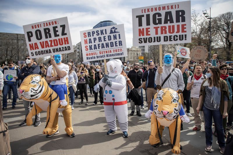 People attend a protest in front of the Serbian parliament in Belgrade