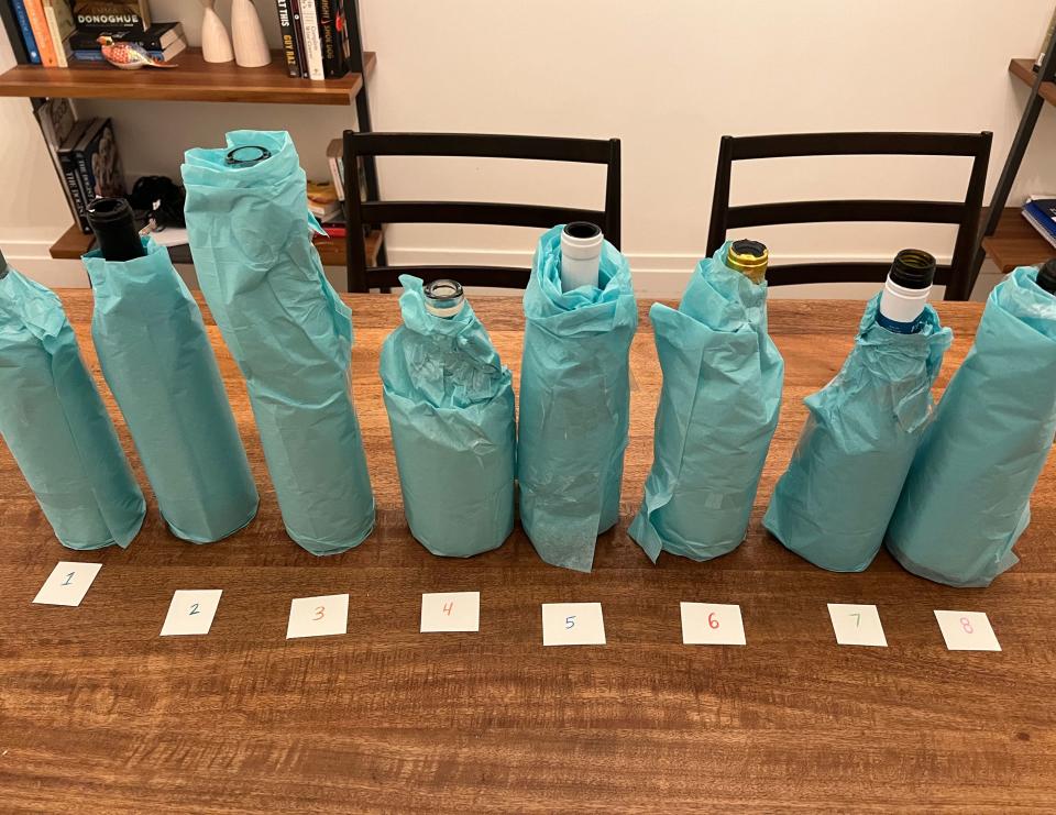 Wrapped-up bottles of wine in a row