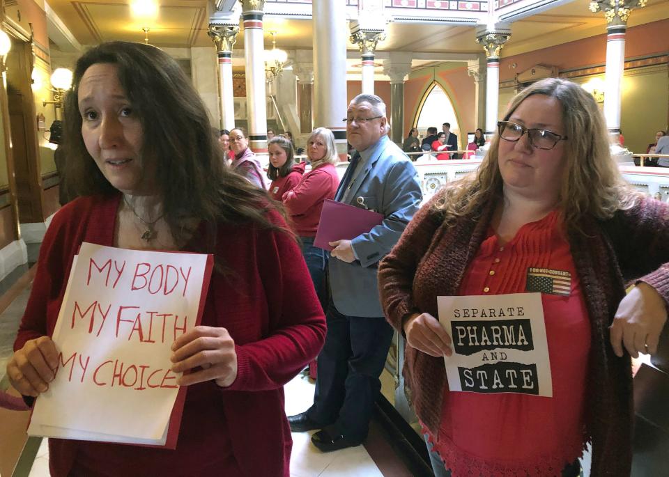 Mothers Ariana Rawls, left, of Stratford, and Shannon Gamache, right, of Ashford, talk to reporters about legislative efforts to change the state's vaccination laws, Wednesday, March 13, 2019, at the Capitol in Hartford, Conn. They were among parents and guardians to voice their opposition to ending the ability to claim a religious exemption from the state's school vaccination requirements. Proponents argue the change is needed to protect the health of the general population. (AP Photo/Susan Haigh)