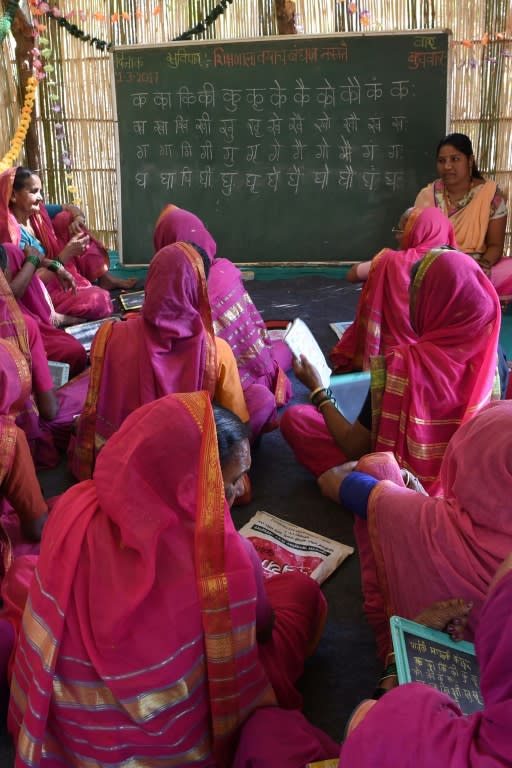 The distinctive pink uniform worn by students at the Aajibaichi Shala, or "school for grannies" helps combat discrimination