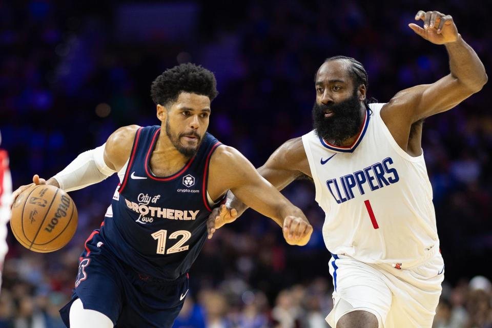 Philadelphia 76ers forward Tobias Harris (12) dribbles the ball against LA Clippers guard James Harden (1) during the second quarter at Wells Fargo Center on March 27, 2024.