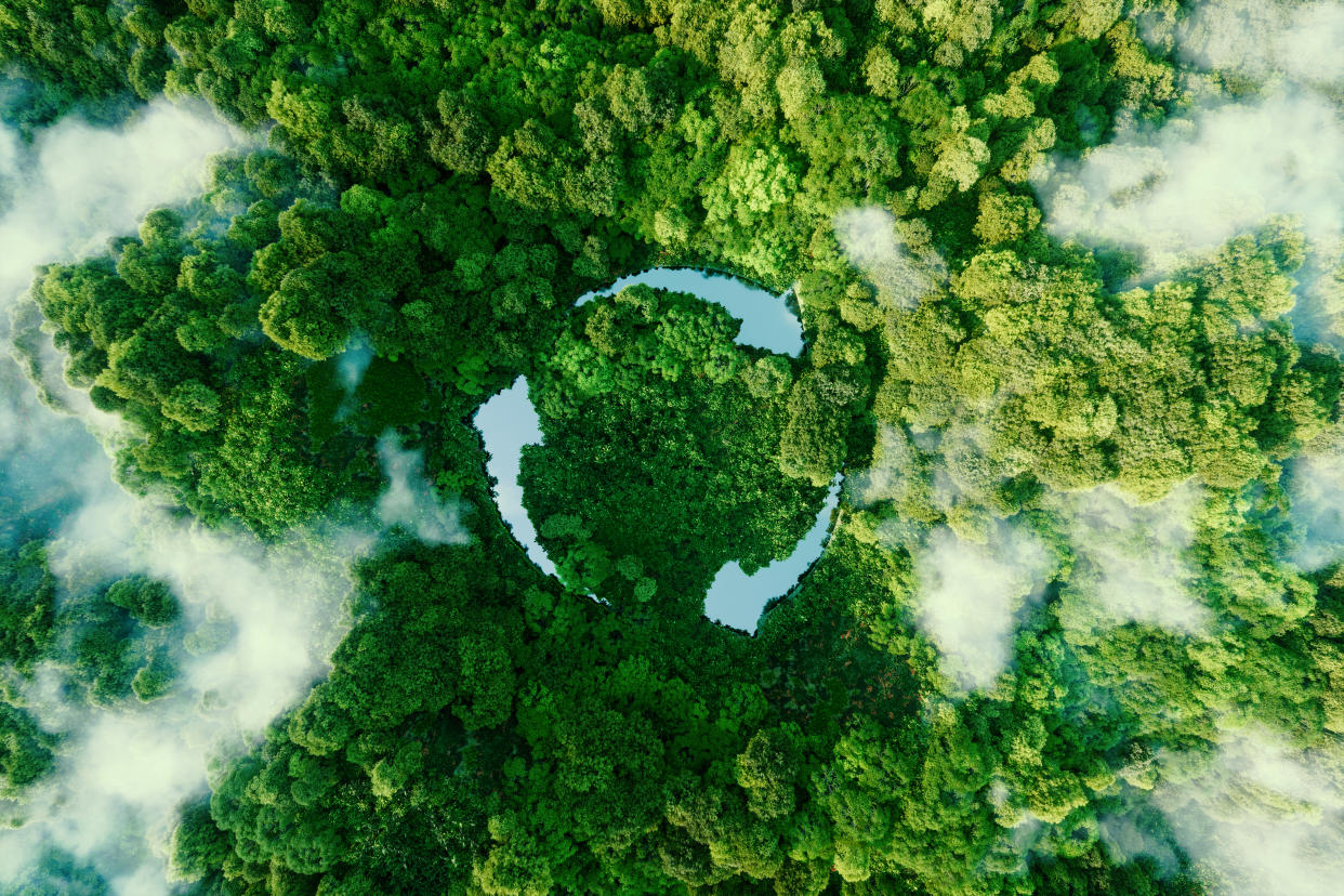 Abstract icon representing the ecological call to recycle and reuse in the form of a pond with a recycling symbol in the middle of a beautiful untouched jungle