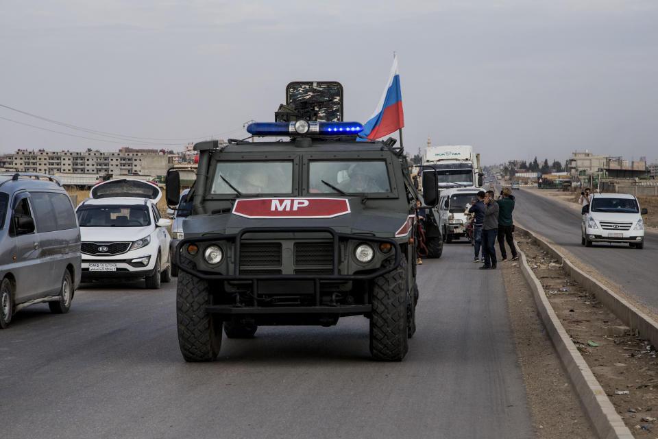 Russian forces patrol near the city of Qamishli, north Syria, Thursday, Oct. 24, 2019. Syrian forces, Russian military advisers and military police are being deployed in a zone 30 kilometers (19 miles) deep along much of the northeastern border, under an agreement reached Tuesday by Russia and Turkey. (AP Photo/Baderkhan Ahmad)