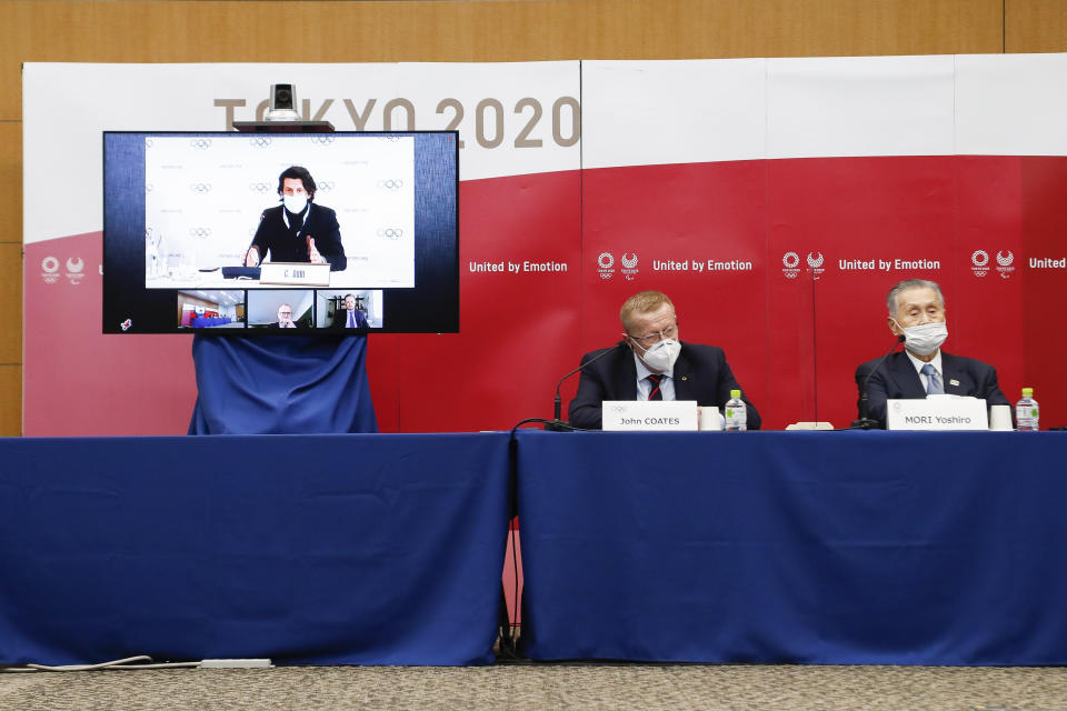 Left to right; Christophe Dubi Executive Director of Olympic Games (on the screen), John Coates Chairman of the Coordination Commission for the Games of the XXXII Olympiad Tokyo 2020 and Yoshiro Mori President of Tokyo 2020, speak during a joint press conference in Tokyo, Wednesday, Nov. 18, 2020. (Rodrigo Reyes Marin/Pool Photo via AP)