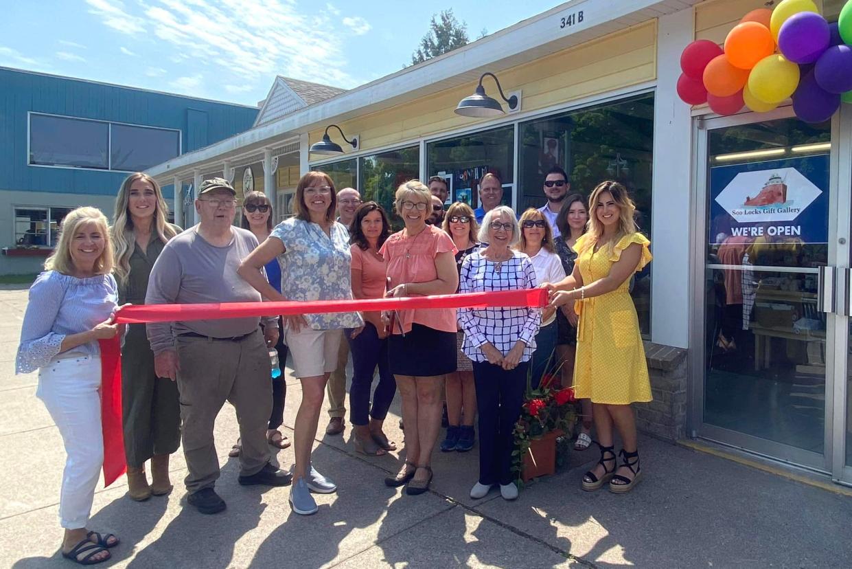 Jill Ann Rambo cuts the ribbon to open her newest business on Portage Street, the Soo Locks Gift Gallery, on June 1.