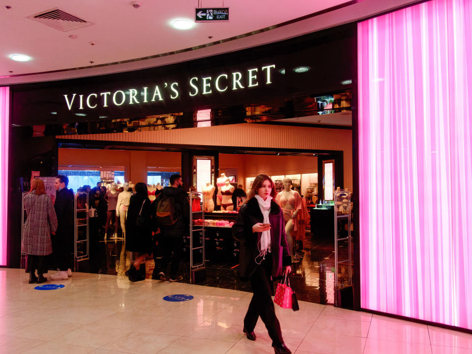 A person walking by a crowded Victoria's Secret