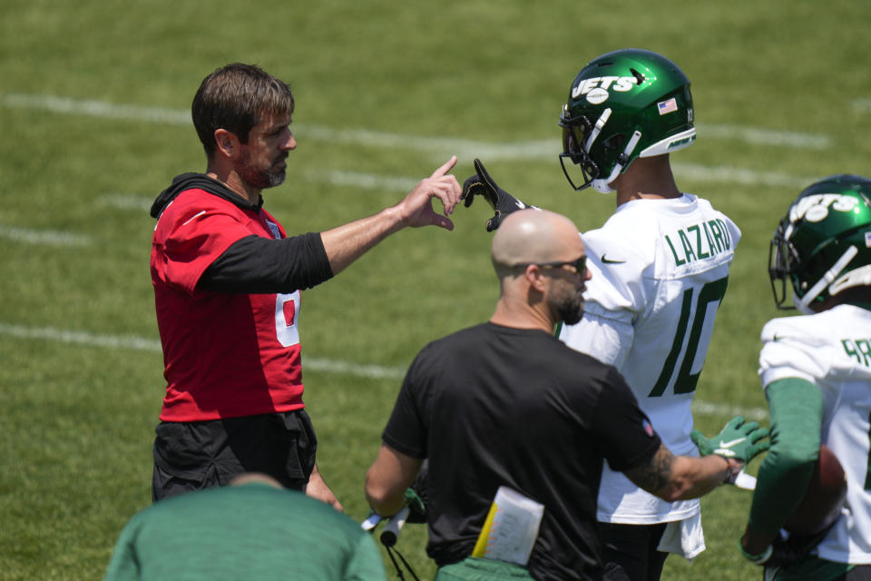 York Jets quarterback Aaron Rodgers, left, greets Allen Lazard during NFL football practice at the team's training facility in Florham Park, N.J., Wednesday, May 31, 2023. (AP Photo/Seth Wenig)
