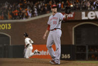 Mat Latos #55 of the Cincinnati Reds gets a new ball while Buster Posey #28 of the San Francisco Giants trots around the bases after hitting a solo home run during the sixth inning in Game One of the National League Division Series at AT&T Park on October 6, 2012 in San Francisco, California. (Photo by Thearon W. Henderson/Getty Images)