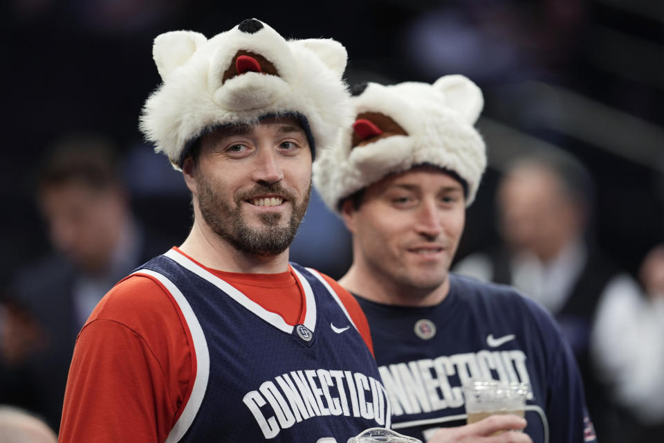 UConn fans watch their team warm up before the start of an NCAA college basketball game against Marquette in the championship of the Big East Conference tournament, Saturday, March 16, 2024, in New York. (AP Photo/Mary Altaffer)
