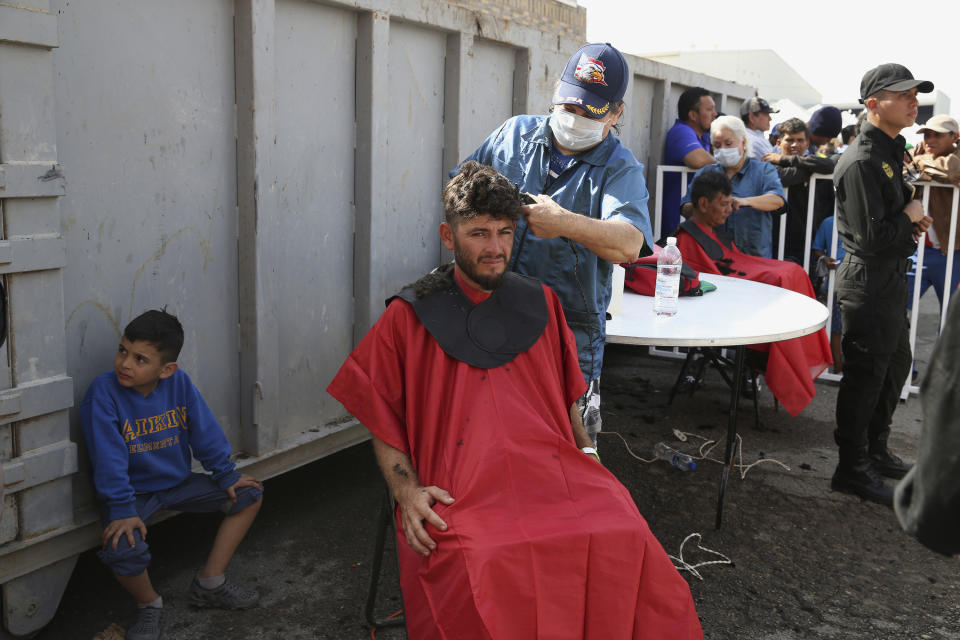 A Central American immigrant gets a haircut at a shelter in Piedras Negras, Mexico, Tuesday, Feb. 5, 2019. A caravan of about 1,600 Central American migrants camped Tuesday in the Mexican border city of Piedras Negras, just west of Eagle Pass, Texas. The governor of the northern state of Coahuila described the migrants as "asylum seekers," suggesting all had express intentions of surrendering to U.S. authorities. (Jerry Lara/The San Antonio Express-News via AP)