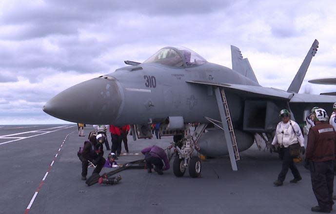 The Ford's crewmembers refuel an F/A-18E Super Hornet on the flight deck.  / Credit: Eleanor Watson