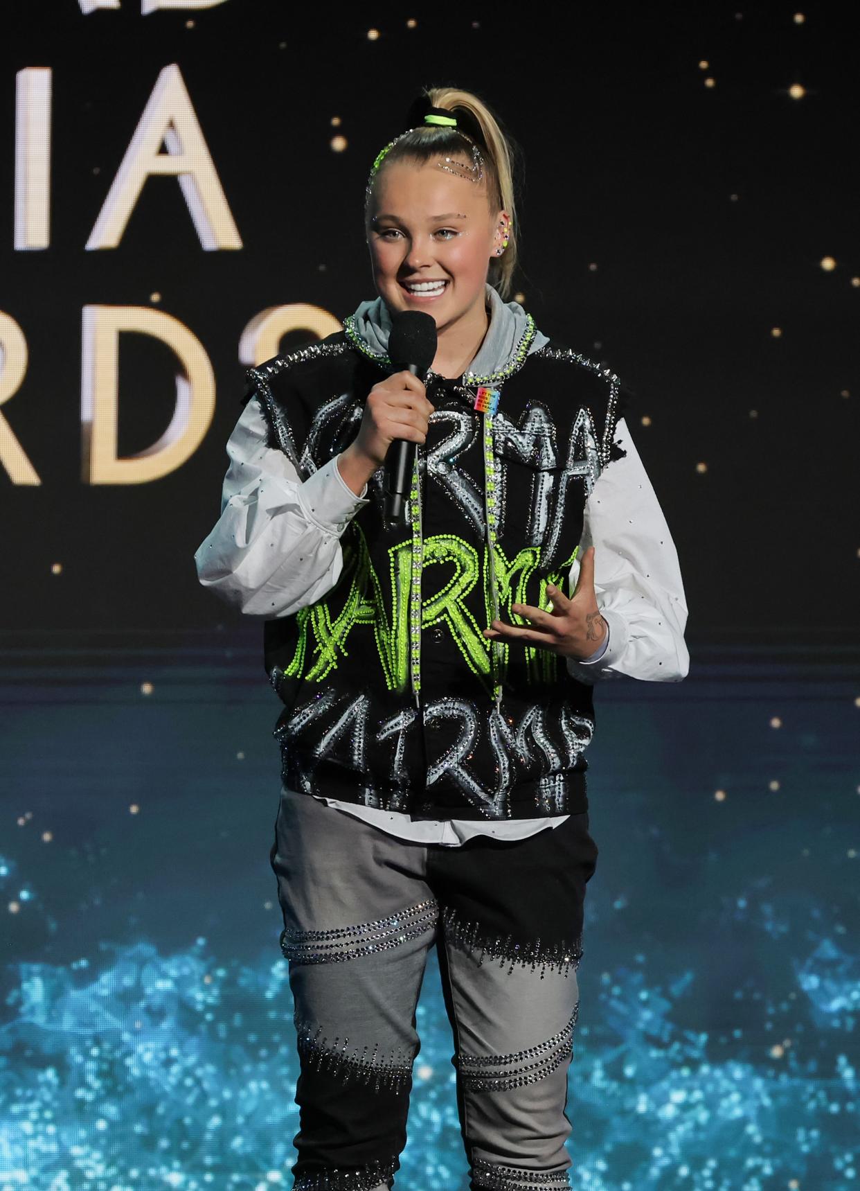 JoJo Siwa speaks onstage during the 35th annual GLAAD Media Awards at The Beverly Hilton on March 14, 2024, in Beverly Hills, California.