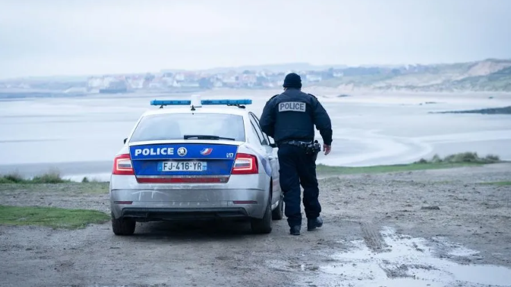File photo of a French Police officer looking out over a beach in France