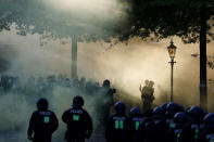 <p>Riot police move in through the smoke during the “Welcome to Hell” rally against the G-20 summit in Hamburg, northern Germany on July 6, 2017. (Photo: Odd Andersen/AFP/Getty Images) </p>