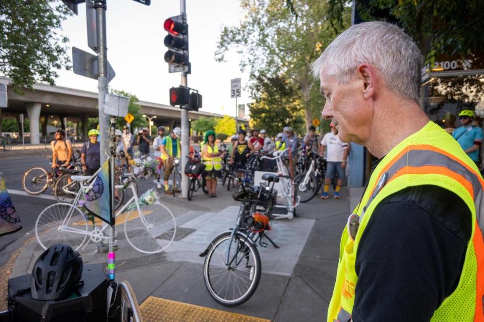 Bob Stanton bows his head during a moment of silence on Wednesday, May 15, 2024, with other riders at 21st and X streets in midtown Sacramento, the location where Johanna Johnston was killed while riding her bike to work, during a “Ride of Silence” tour of cyclist crashes.