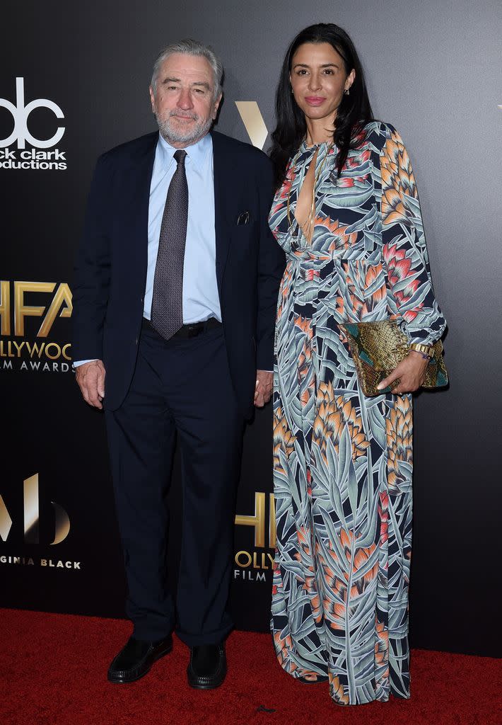 Robert De Niro smiling on a red carpet with his daughter Drena De Niro in 2016