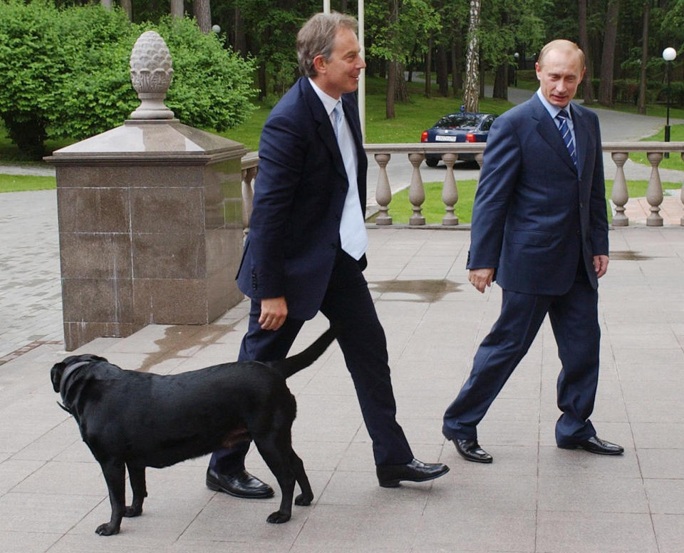 Britain's Prime Minister Tony Blair (left) walks with Russian President Vladimir Putin and his dog Koni at his private dacha outside Moscow.