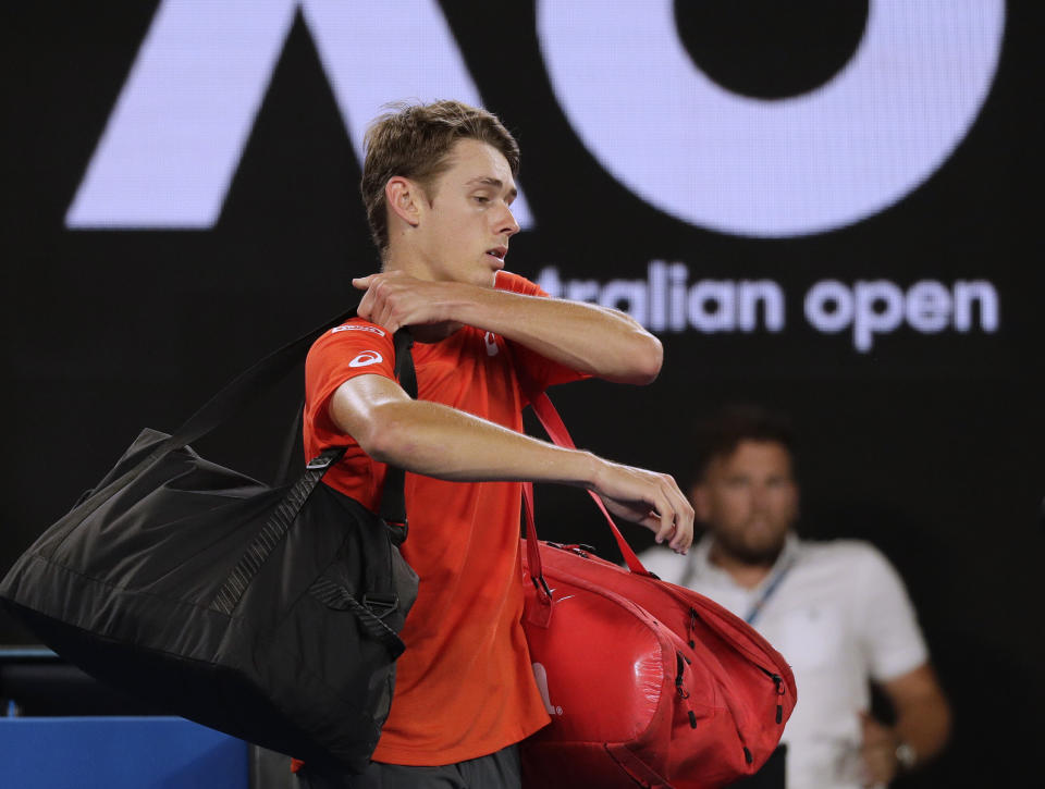 Australia's Alex de Minaur leaves Rod Laver Arena after losing his third round match against Spain's Rafael Nadal at the Australian Open tennis championships in Melbourne, Australia, Friday, Jan. 18, 2019. (AP Photo/Kin Cheung)