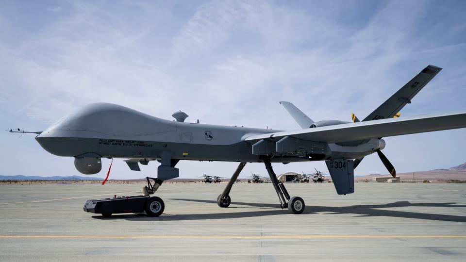 A TowFLEXX TF3 aircraft tug hauls an MQ-9 Reaper along a runway at Marine Corps Air Ground Combat Command Center, Twentynine Palms, California, Feb. 16, 2023. Agile Combat Employment Reaper 23.6 saw Airmen from Holloman Air Force Base, Cannon AFB, N.M., and Creech AFB, Nevada, participated in Agile Combat Employment Reaper 23.6 at Twentynine Palms to hone their skills while also supporting RPA training for the Marines. (U.S. Air Force photo by Staff Sgt. Kristin West)