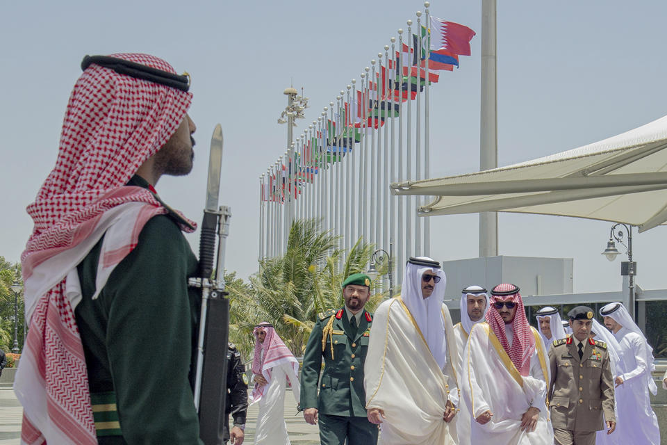 In this photo provided by Saudi Press Agency, SPA, Emir of Qatar Sheikh Tamim bin Hamad Al Thani, center, accompanied by Prince Badr Bin Sultan, deputy governor of Mecca, right, upon his arrival at Jeddah airport, Saudi Arabia, Friday, May 19, 2023, to attend the Arab summit. (Saudi Press Agency via AP)