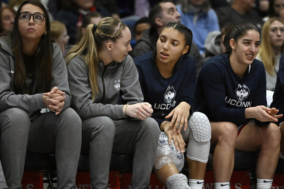 FILE - UConn's Paige Bueckers, second from left, talks with teammate Azzi Fudd during the second half of an NCAA college basketball game Jan. 15, 2023, in Hartford, Conn. Bueckers, the national player of the year as a freshman and a pre-season All-American this year, missed all of last season and most of the previous one with two separate knee injuries. Fudd has also had injuries that put her on the bench for significant portions of both her freshman and sophomore seasons at UConn. (AP Photo/Jessica Hill, File)