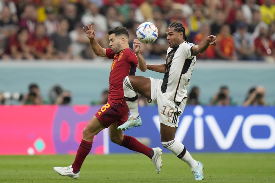 Germany's Serge Gnabry vies for the ball with Spain's Jordi Alba, left, during the World Cup group E soccer match between Spain and Germany, at the Al Bayt Stadium in Al Khor , Qatar, Sunday, Nov. 27, 2022. (AP Photo/Matthias Schrader)