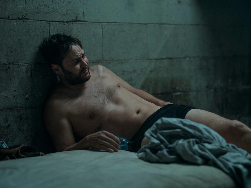 Glen (Taylor Kitsch) lies on a mattress on the floor in the midst of withdrawal from OxyContin on "Painkiller."