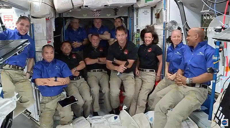 The expanded 11-member station crew crowded together for a post-docking portrat. Left to right in blue shirts: Michael Hopkins, Soichi Noguchi, Mark Vande Hei, Oleg Novitskiy, Pyotr Dubrov, Shannon Walker and Victor Glover. Left to right in black shirts: Akihiko Hoshide, Shane Kimbrough, Thomas Pesquet and Megan McArthur. / Credit: NASA TV