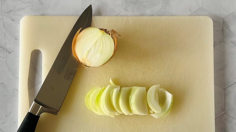 chopping onion on cutting board