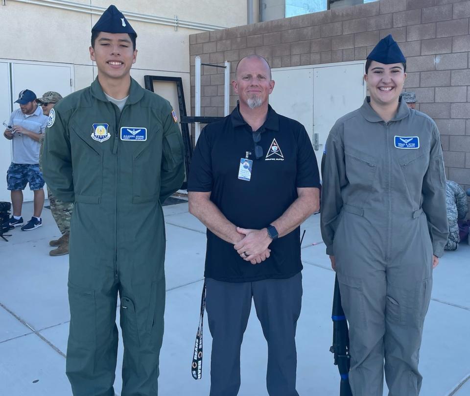 Academy for Academic Excellence Principal Chet Richards is flanked by Space Force JROTC cadets Natalie Ritter and Alejandro Aguirre.