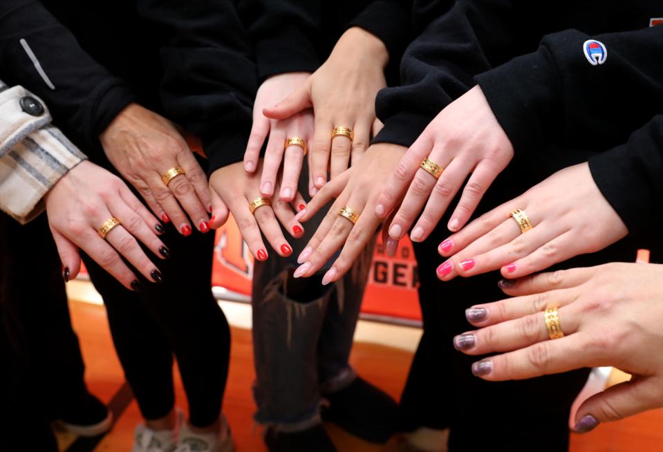 Championship field hockey players show off their rings while posing for a team photo, as Mamaroneck High School held a championship ring ceremony at the school Jan. 12, 2024, to celebrate their 2023 New York State Championship where they defeated Orchard Park, 4-0 on Nov. 12, 2023.