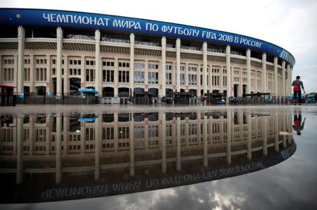 Luzhniki stadium is reflected in a puddle in Moscow, Russia, June 30, 2018. REUTERS/Christian Hartmann