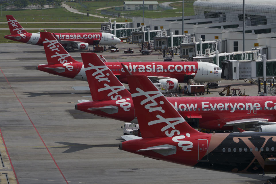 AirAsia Airbus planes sit on the tarmac at a terminal in Sepang, Malaysia, Monday, Nov. 15, 2021. Malaysia's AirAsia Group said Friday, Jan. 28, 2022, it has officially changed the name of its listed holding company to Capital A to reflect the diversity of its business portfolio as it seeks to grow its non-airline revenue. (AP Photo/Vincent Thian)