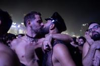 TOPSHOT - Fans kiss as they watch US pop star Madonna perform during a free concert at Copacabana beach in Rio de Janeiro, Brazil, on May 4, 2024. . Madonna ended her "The Celebration Tour" with a performance attended by some 1.5 million enthusiastic fans. (Photo by TERCIO TEIXEIRA / AFP) (Photo by TERCIO TEIXEIRA/AFP via Getty Images)