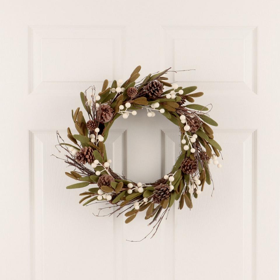 Wondershop 18-inch Christmas Unlit Green Felt Leaves White Berries Pinecones Artificial Wreath. (Photo: Target)