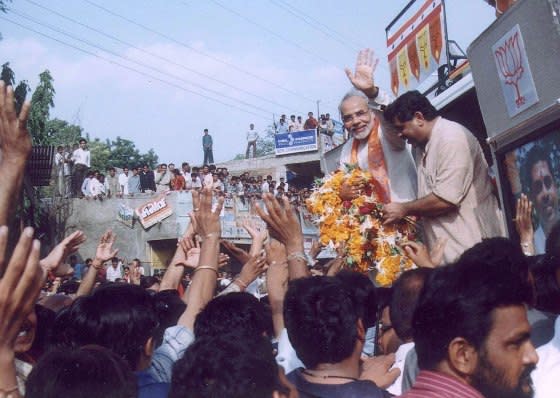 Gujarat Chief Minister Narendra Modi waves to supporters in Kadi, 40 km north of the state’s main city Ahmedabad, on September 9, 2002.<span class="copyright">Amit Dave—Reuters</span>