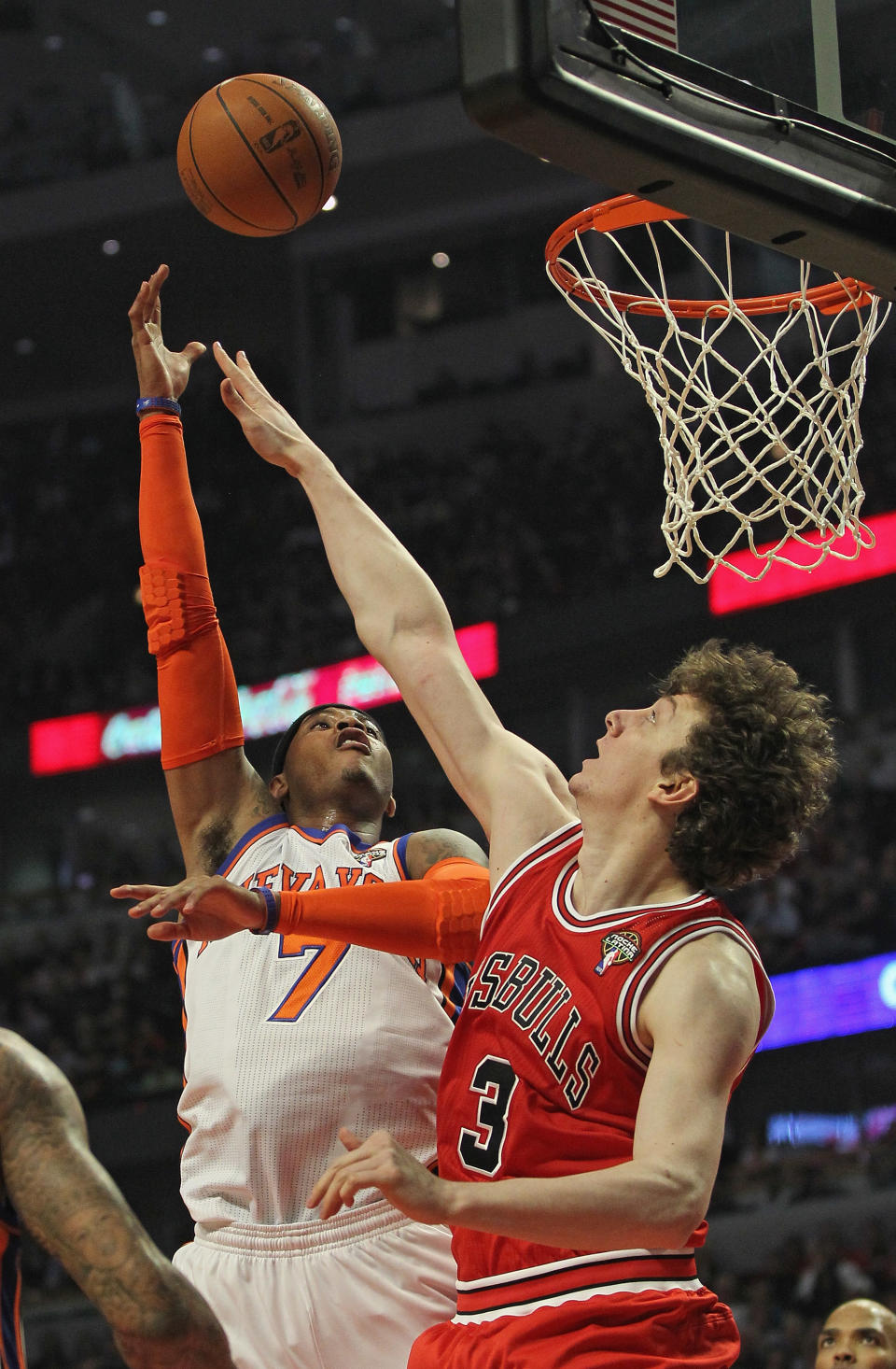 CHICAGO, IL - MARCH 12: Carmelo Anthony #7 of the New York Knicks puts up a shot over Omer Asik #3 of the Chicago Bulls at the United Center on March 12, 2012 in Chicago, Illinois. NOTE TO USER: User expressly acknowledges and agrees that, by downloading and or using this photograph, User is consenting to the terms and conditions of the Getty Images License Agreement. (Photo by Jonathan Daniel/Getty Images)