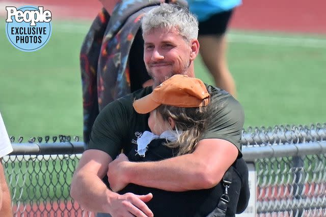 MEGA / BACKGRID Ant Anstead hugs Renée Zellweger following a soccer win