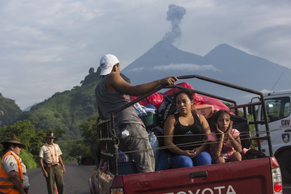 Villagers stop at a government checkpoint in Guatemala as the Volcan de Fuego expels gas near San Miguel Los Lotes on June 12, 2018. (Photo: Rodrigo Abd/AP)