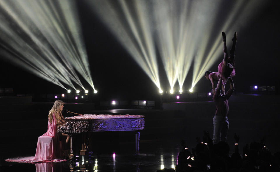 Taylor Swift, left, winner of the artist of the decade award, performs a medley at the American Music Awards on Sunday, Nov. 24, 2019, at the Microsoft Theater in Los Angeles. (Photo by Chris Pizzello/Invision/AP)