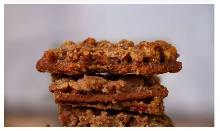 A closeup of a stack of pecan pie bars