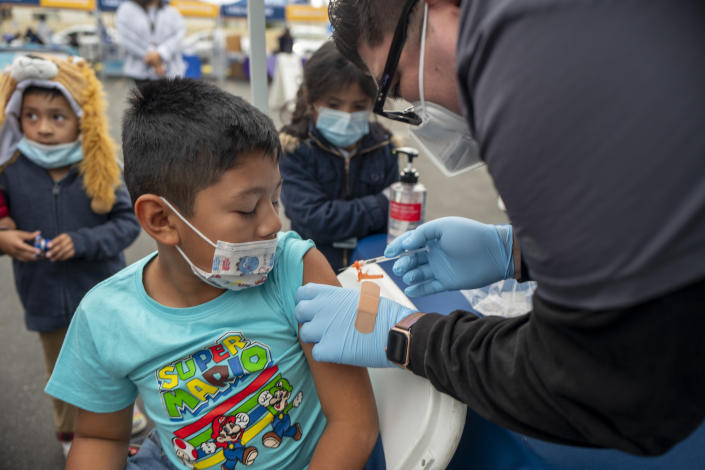 A boy receives a shot.