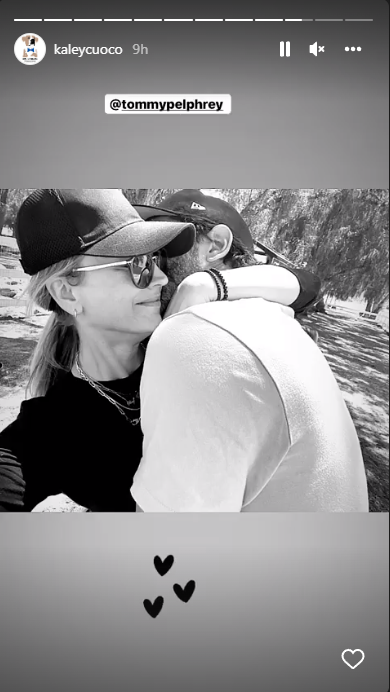 Kaley Cuoco and Tom Pelphrey hug. Black and white image