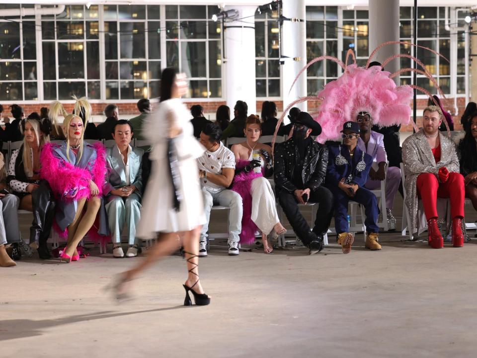 Celebrity attendees watch Christian Cowan's Fall/Winter 2023 runway show.
