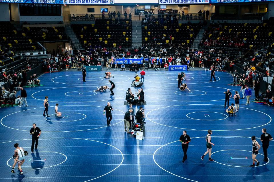 Wrestlers compete on eight mats during the Dan Gable Donnybrook high school wrestling tournament, Friday, Dec. 3, 2021, at the Xtream Arena in Coralville, Iowa.