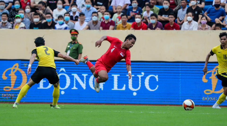 Singapore left-back Nur Adam Abdullah chases for the ball during their match against Malaysia at the Hanoi SEA Games. (PHOTO: SNOC/Kelly Wong)